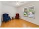 Bright bedroom features wood floor, two chairs and natural light at 1243 Tangerine Cir, Lady Lake, FL 32159