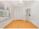 Bedroom featuring wood floor, double door closet, window and white trim at 1243 Tangerine Cir, Lady Lake, FL 32159