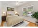 Comfortable bedroom features natural light from the window, ceiling fan, neutral colors, and a cozy bed at 1243 Tangerine Cir, Lady Lake, FL 32159
