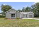 Charming single-story home featuring a well-maintained lawn and neutral-toned siding at 1243 Tangerine Cir, Lady Lake, FL 32159