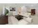 Bright living room with tile flooring, vaulted ceilings, and sophisticated neutral decor at 1243 Tangerine Cir, Lady Lake, FL 32159