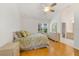 Bright bedroom with hardwood floors, a ceiling fan, and a large window at 1243 Tangerine Cir, Lady Lake, FL 32159