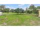 A home's backyard featuring a well-maintained lawn with perimeter trees at 136 Triplet Lake Dr, Casselberry, FL 32707