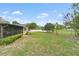 A sprawling backyard with a screen patio and lush greenery; well maintained landscaping at 136 Triplet Lake Dr, Casselberry, FL 32707
