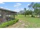 A home's backyard featuring an outdoor patio with a spacious green lawn at 136 Triplet Lake Dr, Casselberry, FL 32707