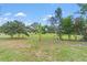 A spacious backyard with vibrant green grass and chain link fence outlining the property at 136 Triplet Lake Dr, Casselberry, FL 32707