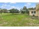 A home's backyard featuring a well-maintained lawn and green spaces at 136 Triplet Lake Dr, Casselberry, FL 32707