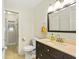 Bathroom with vanity and toilet featuring tiled floor and plenty of light at 136 Triplet Lake Dr, Casselberry, FL 32707