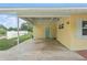A home exterior featuring a carport area with a blue door entrance at 136 Triplet Lake Dr, Casselberry, FL 32707