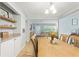 Dining room featuring built-in shelves, a large wooden table, and seamless flow into the living spaces at 136 Triplet Lake Dr, Casselberry, FL 32707
