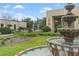 Close-up of tiered fountain in landscaped courtyard of building featuring colorful exterior artwork at 136 Triplet Lake Dr, Casselberry, FL 32707