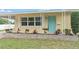 Inviting single-story home with a charming light blue front door and well-maintained landscaping at 136 Triplet Lake Dr, Casselberry, FL 32707