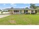 Charming single-story home featuring a well-manicured lawn and a covered carport at 136 Triplet Lake Dr, Casselberry, FL 32707