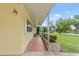 Welcoming covered front porch with beautiful plants and greenery at 136 Triplet Lake Dr, Casselberry, FL 32707