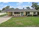 Charming home with a well-manicured front lawn and ample greenery at 136 Triplet Lake Dr, Casselberry, FL 32707