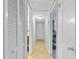 Bright hallway featuring neutral paint, tiled floors, and closet for storage at 136 Triplet Lake Dr, Casselberry, FL 32707