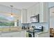 Bright kitchen boasts modern white cabinets, granite countertops, and stainless steel appliances at 136 Triplet Lake Dr, Casselberry, FL 32707