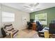 A bright office space with two windows and an overhead ceiling fan at 136 Triplet Lake Dr, Casselberry, FL 32707