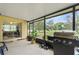 Screened-in patio with a view of the spacious backyard, complete with a grill at 136 Triplet Lake Dr, Casselberry, FL 32707