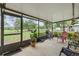 Screened-in patio showcasing a lush backyard view, complete with grill and outside seating at 136 Triplet Lake Dr, Casselberry, FL 32707