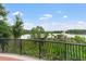 A scenic view of the pond at Lake Concord Park from behind a decorative fence at 136 Triplet Lake Dr, Casselberry, FL 32707