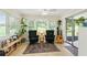 Bright sun room with large windows, comfortable seating, and a sliding glass door that leads outside at 136 Triplet Lake Dr, Casselberry, FL 32707