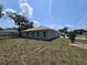 Wide angle backyard view of home showing covered porch and multiple windows at 141 W G H Washington St, Apopka, FL 32703