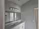 Bathroom featuring double sink vanity with sleek mirror under construction and newly painted at 141 W G H Washington St, Apopka, FL 32703