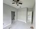 Bedroom features a ceiling fan, closet, and door to bathroom at 141 W G H Washington St, Apopka, FL 32703