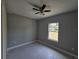 Bedroom with a ceiling fan and a view from the window at 141 W G H Washington St, Apopka, FL 32703