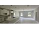 Unfinished kitchen featuring white cabinets, island sink, and gray walls under construction at 141 W G H Washington St, Apopka, FL 32703