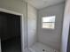 Bathroom with tiled shower and window at 141 W G H Washington St, Apopka, FL 32703