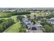 Aerial view of homes with solar panels near a golf course and pond at 1467 Selbydon Way, Winter Garden, FL 34787