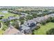 Aerial view of homes with screened-in pools near a golf course and pond at 1467 Selbydon Way, Winter Garden, FL 34787