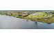 Aerial view of waterfront homes with docks, sprinklers, and picturesque landscaping at 1467 Selbydon Way, Winter Garden, FL 34787