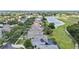 Aerial view of homes with solar panels near a golf course and pond at 1467 Selbydon Way, Winter Garden, FL 34787