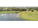 Waterfront golf community showcasing the green course and the tranquil pond at 1467 Selbydon Way, Winter Garden, FL 34787