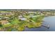 Beautiful aerial view of the community featuring a pool, tennis courts, and waterfront access at 1467 Selbydon Way, Winter Garden, FL 34787