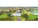 Aerial view showcases the community clubhouse with a pool and manicured green spaces at 1467 Selbydon Way, Winter Garden, FL 34787