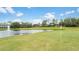 Picturesque golf course community with lush greenery and a serene pond at 1467 Selbydon Way, Winter Garden, FL 34787