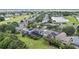Aerial view of homes with screened-in pools near a golf course and pond at 1467 Selbydon Way, Winter Garden, FL 34787