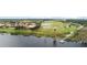 Aerial showcases waterfront homes, docks, and sprinklers on a lush green golf course at 1467 Selbydon Way, Winter Garden, FL 34787