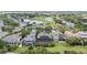 Aerial view of homes with screened-in pools near a golf course and pond at 1467 Selbydon Way, Winter Garden, FL 34787