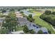 Aerial view of homes with solar panels near a golf course and pond at 1467 Selbydon Way, Winter Garden, FL 34787