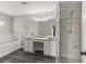 Modern bathroom with double vanity, luxurious tub, glass shower, and sleek fixtures at 1467 Selbydon Way, Winter Garden, FL 34787