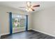 Bedroom with wood floors, a window with a neighborhood view, and blue curtains at 1467 Selbydon Way, Winter Garden, FL 34787