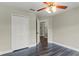 Bedroom features wood floors, view of hall, and a double door closet for storage at 1467 Selbydon Way, Winter Garden, FL 34787