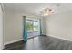 Bedroom with ceiling fan, wood floors, sliding glass doors that lead to outdoor balcony at 1467 Selbydon Way, Winter Garden, FL 34787