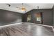 Large bonus room with dark accent walls, ceiling fan, and elegant flooring at 1467 Selbydon Way, Winter Garden, FL 34787