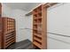 Walk-in closet provides ample storage with custom shelving and dark wood-look flooring at 1467 Selbydon Way, Winter Garden, FL 34787